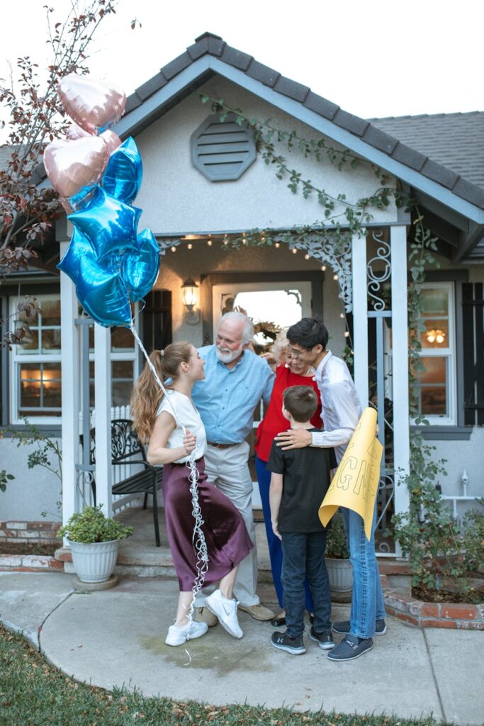 A joyous family celebration at home with balloons and laughter outdoors.